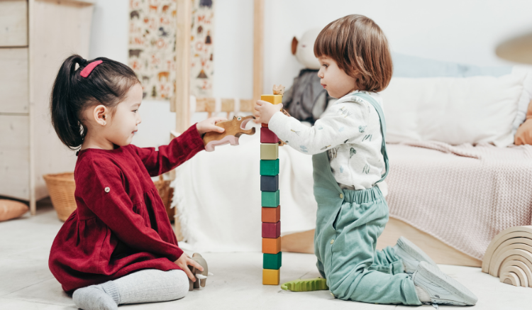 two young children playing with blocks