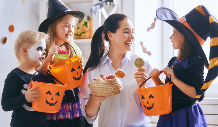 childcare owner celebrating halloween with young children 