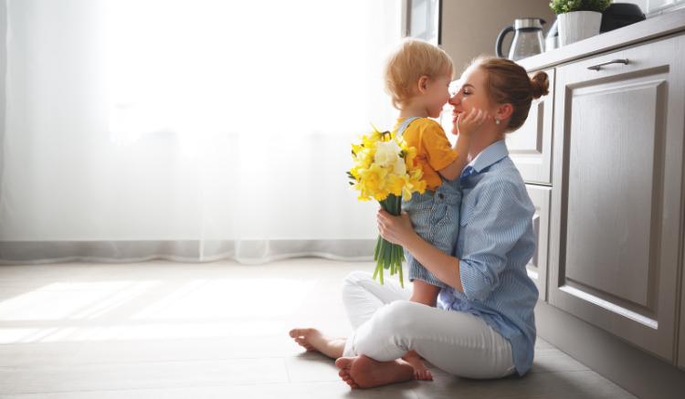 childcare provider sitting with young child